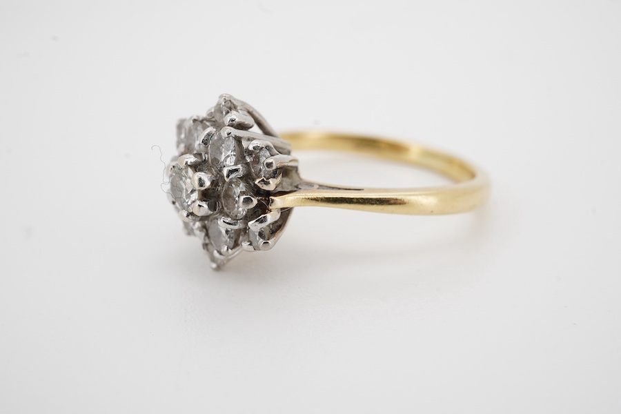 A yellow metal (stamped 18ct) and diamond set flower head cluster ring, size M, gross weight 4.1 grams. Condition - fair to good